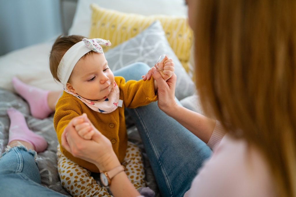 Mother and baby playing and smiling. Happy family