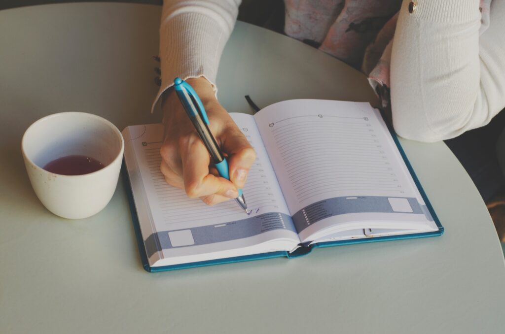Business woman. Girl writes in a notebook. routine